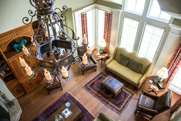 aerial view of a spacious living room with a lodge cabin style with earth-tone furniture and a fireplace