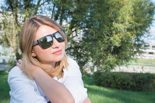 portrait of a beautiful pensive woman in sunglasses