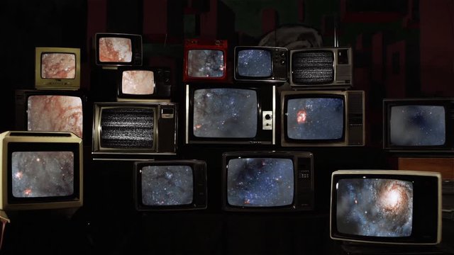 Stacked Retro TVs with a Galaxy as a Background. Elements of this video furnished by NASA.