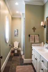 small green guest bathroom with toilet and sink