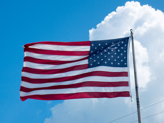 American flag against clouds