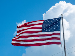 American flag against clouds
