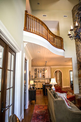 Stylish and rustic cabin lodge living room den area with pine built-in, chandelier and view of the upstairs