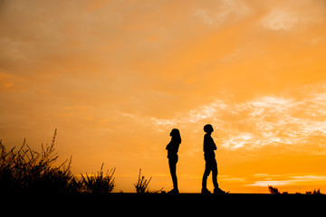 Break Up, Bad relationship, Anger, unhappy, concept. Silhouette of anger of couples love who are quarreling (argument) and standing back to back with sunset background in Thailand