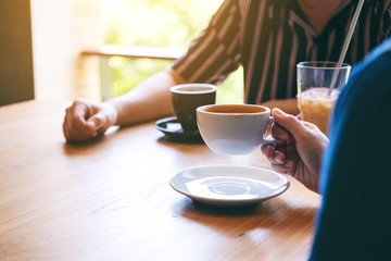Closeup image of people enjoyed drinking coffee together