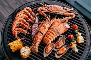 Lobster and mix seafood barbecue cokking on grill