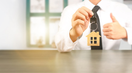 Real estate agent handing over house keys