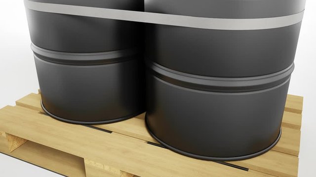 Close-up of two metal black barrels with oil symbol located on wooden pallet isolated on white background. Barrels are strapped by tape. Camera pedestal movement, lift. 60 fps animation.