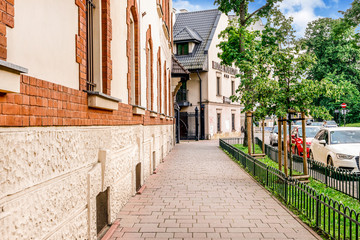 KRAKOW, POLAND - MAY 25, 2019: Old tenements and city park
