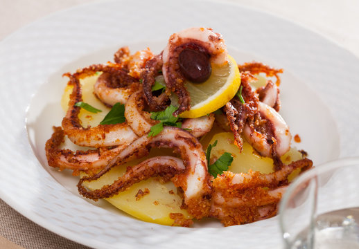 Fried tentacles squid with potatoes