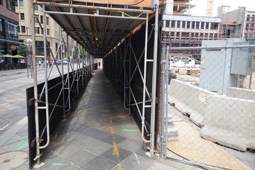 A pathway covered in scaffolding.