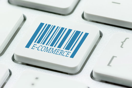 Ecommerce and retail sale concept : Unusable model barcode with a word e-commerce on computer button / laptop keyboard, depict buyers or customers order or buy things from retailer site using internet