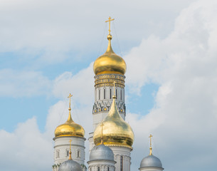 Fototapeta na wymiar golden domes of the church with crosses against the sky