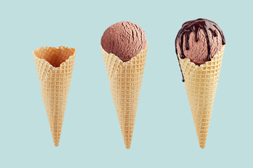 Set of chocolate ice cream cones in  waffle cone - empty, brown ice cream, with chocolate sauce on green color.