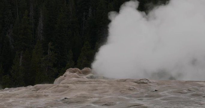 Yellowstone National Park Old Faithful steam venting. Cone geyser predictable geothermal ecosystem environment. Caldera superolcano. Biology geography and ecology.