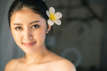 Fototapeta premium Asian Beautiful, young and healthy woman in spa salon. Massage treatment spa room . Traditional medicine and healing concept.