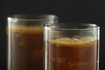 Glasses with cuba libre cocktail or cola with ice or cold tea with lemon