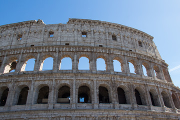 Fototapeta na wymiar Detailed view of Colosseum with blue sky on background, Rome, Lazio, Italy.