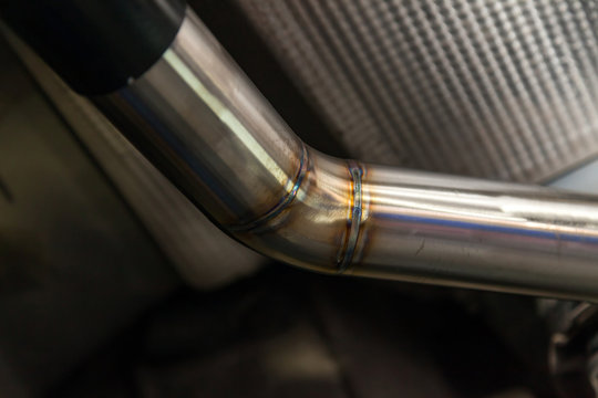 Fabrication and installation of a stainless steel car exhaust pipe with a bifurcation and a louder sound with a color weld under bottom. Tuning and auto service industry.