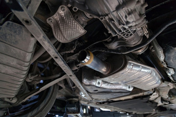 Close-up on the part of the bottom of the car from the front of the exhaust pipe and the catalyst...
