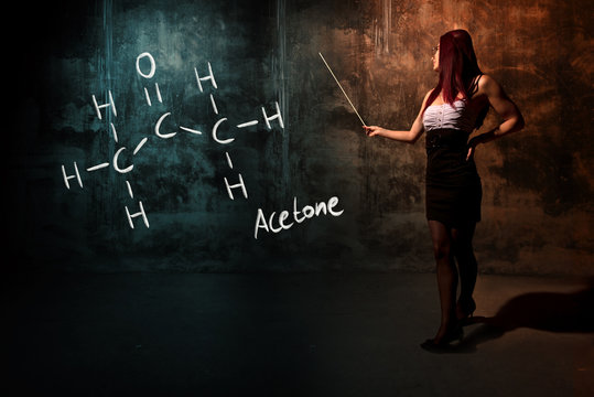 Sexy girl or secretary or female student presenting handdrawn chemical formula of acetone