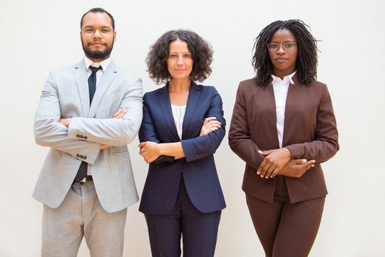 Successful Diverse Business Team Posing With Arms Folded. Business Man And Women Standing Over White Background And Looking At Camera. Successful Business People Concept