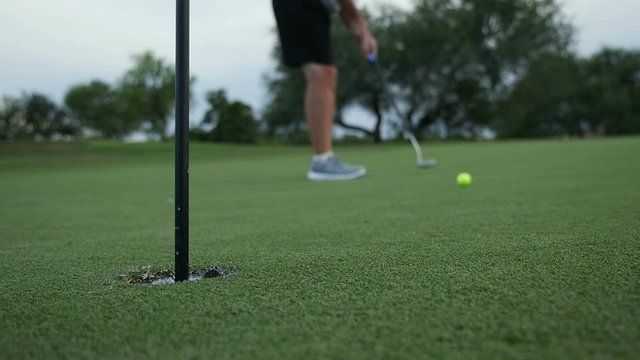 Making a putt on a golf course green