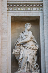 Fototapeta na wymiar Statue representing the abundance in the Trevi Fountain or Fontana di Trevi in Rome, Italy