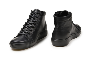 Men's black leather shoes and a black camera on a isolated on white background. Copy space.