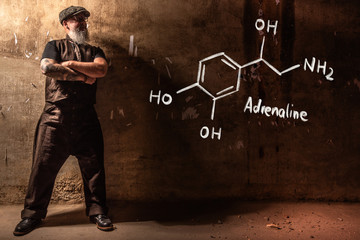 Bearded old man presenting handdrawn chemical formula of adrenaline © artefacti