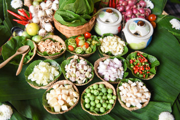 Savoury Leaf Wraps herbs and spices ingredients spicy soup fresh vegetables for Tom Yum thai with slice piece lemon grass garlic galangal chilli lime  tomato shallot peanut on tray Thai Food Asian