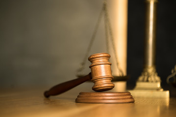 Law and Justice, judge gavel with scales on wooden table.