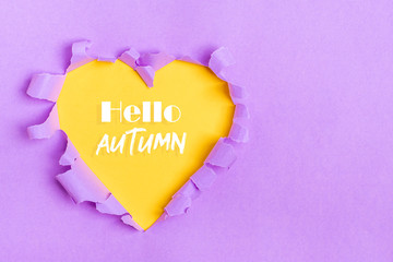 Yellow Heart shape hole through violet paper Flat lay Happy Valentines day concept Copy space for advertising, to insert text or slogan. Discount, sale, season sales.