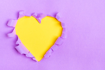 Naklejka na ściany i meble Yellow Heart shape hole through violet paper Flat lay Happy Valentines day concept Copy space for advertising, to insert text or slogan. Discount, sale, season sales.