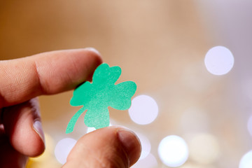  leaf of clover shape cut from paper in the hand
