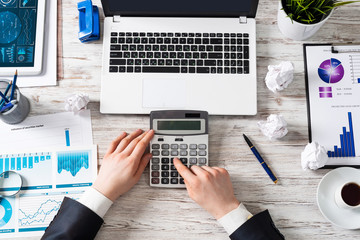 Businessman working at office desk with data
