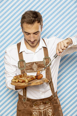 Front view of man with plate of german sausages