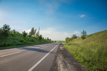 Asphalt highways and mountains under the blue sky