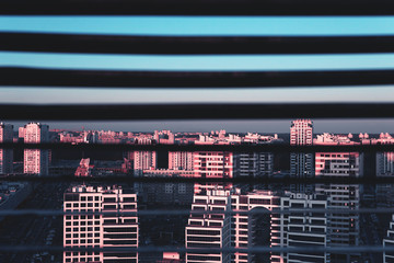 Top view of the city at dawn through the blinds. The concept of the city as a prison. Trendy...