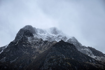 Stunning moody dramatic Winter landscape image of snowcapped Y Garn mountain in Snowdonia