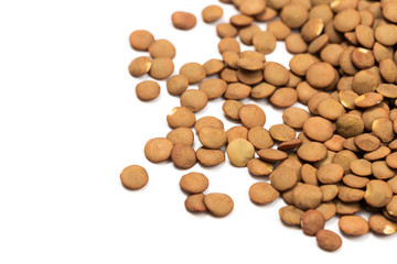 Isolated stack of uncooked lentils on white background from above.