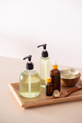 Gel shower and peeled aloe vera on a wooden background