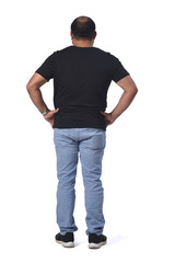 portrait of a man with his back  with hands on waist on white background