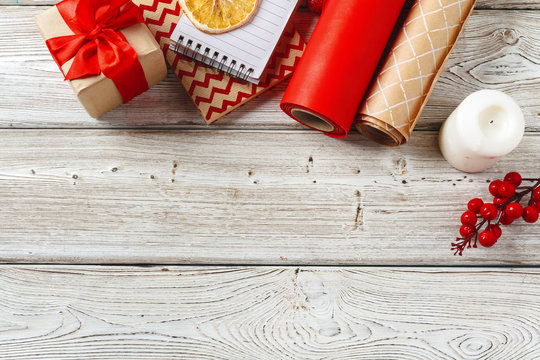 Christmas decorations and gift wrapping items on wooden background, copy space