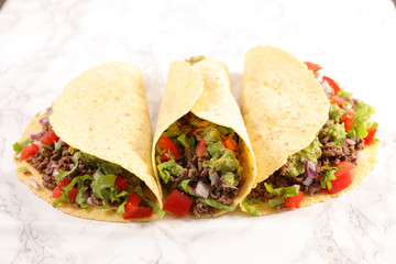 mexican meal, fajitas with minced beef, tomato, salad, onion and avocado