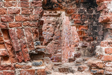 old brick house with an opening in the wall