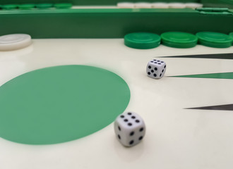 Close up of a backgammon with a pair of dices showing the number six.