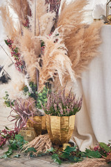 Wedding decoration in boho style. Light colors, in the tent.Wedding table decorated with pampas...