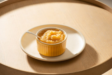 Natural baby food concept. Bowl of apple baby puree.