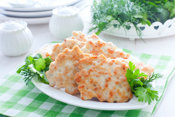 Chopped cutlets of turkey fillet with fresh herbs on a white plate, horizontal